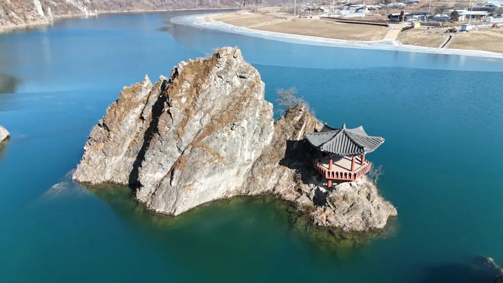 Panoramic view of 도담삼봉 in Danyang, South Korea, with three iconic rock peaks rising from the river surrounded by lush mountains.